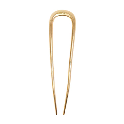 Gold hairpin on a light gray background
